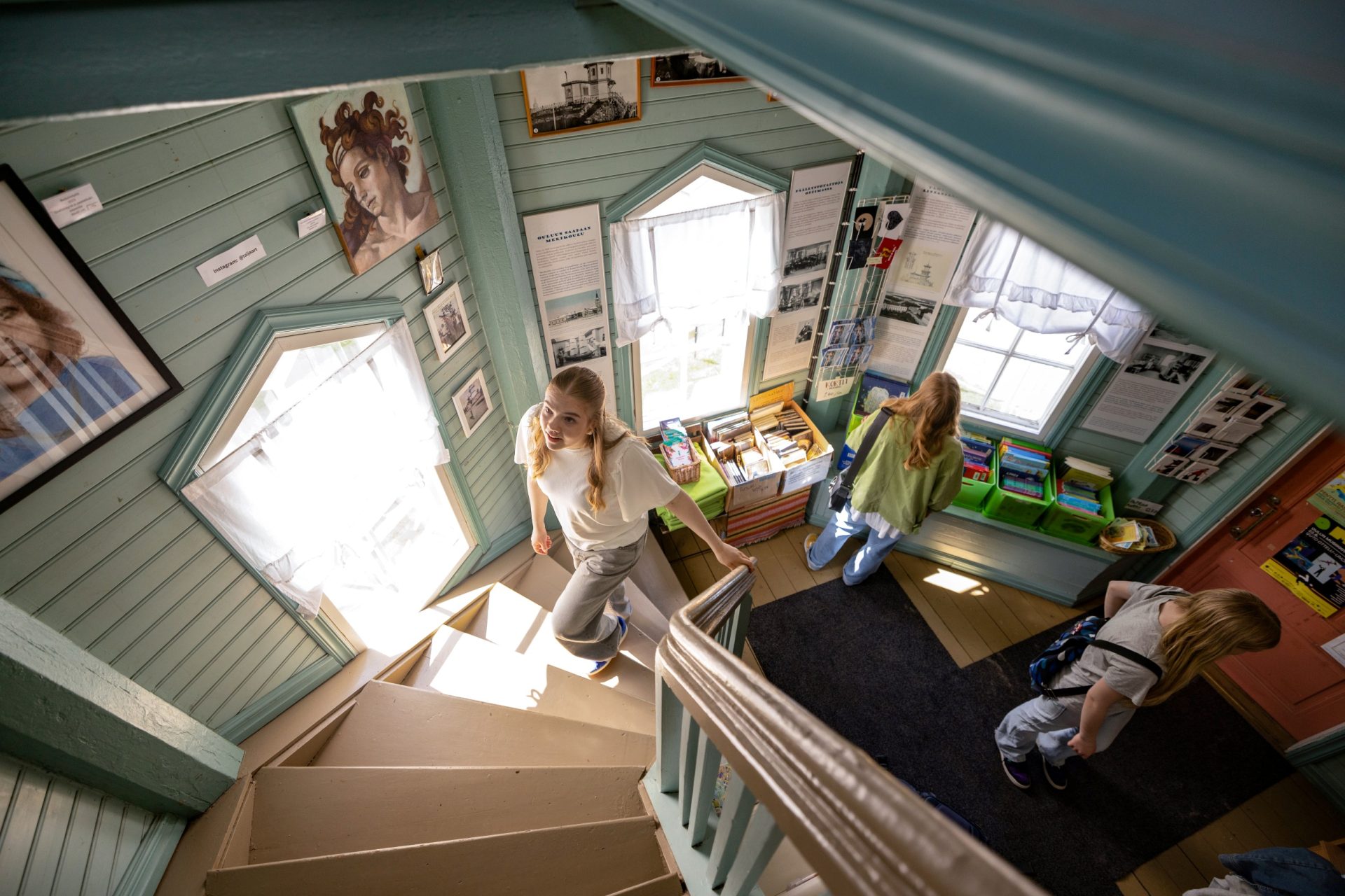 A young woman is climbing up the stairs towards the camera.